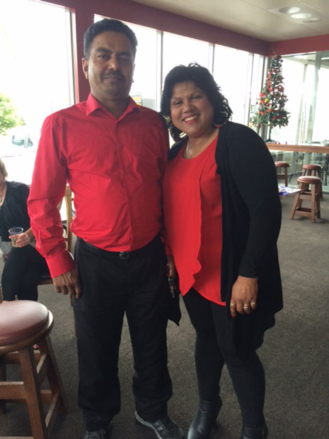 Birendra and Lakshmi Kumar looking festive in matching red shirts.