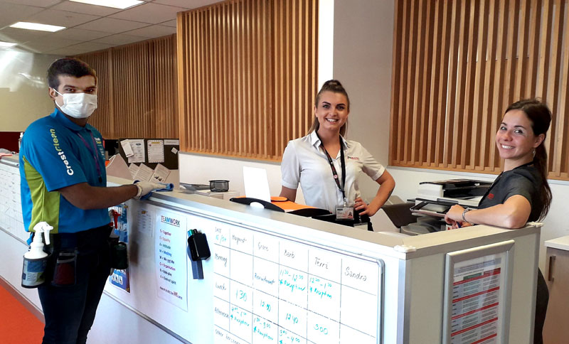 Smit Chaudhari ensures all surfaces are cleaned with an anti-viral sanitiser. He is seen with staff at the New Zealand Blood Service in Christchurch.