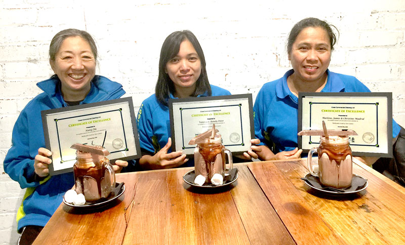 Kim Jin, Vanessa Potot and Marlene Madrid celebrate receiving their awards over a hot chocolate. 