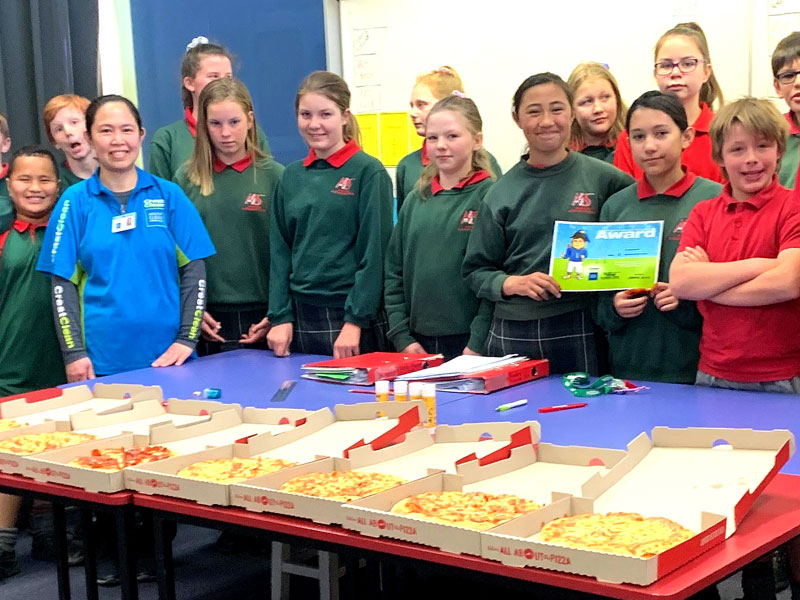 Joy Pombo is popular with students as she hands out pizza at Ashburton Intermediate School.