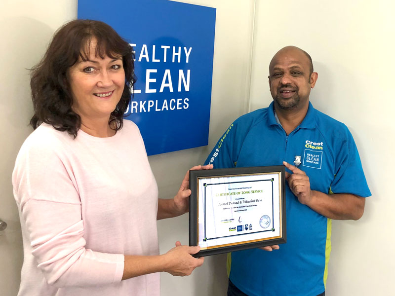 Anmol Prasad receives his 10-year long service award from Linda Hill, CrestClean’s Auckland East Regional Manager.