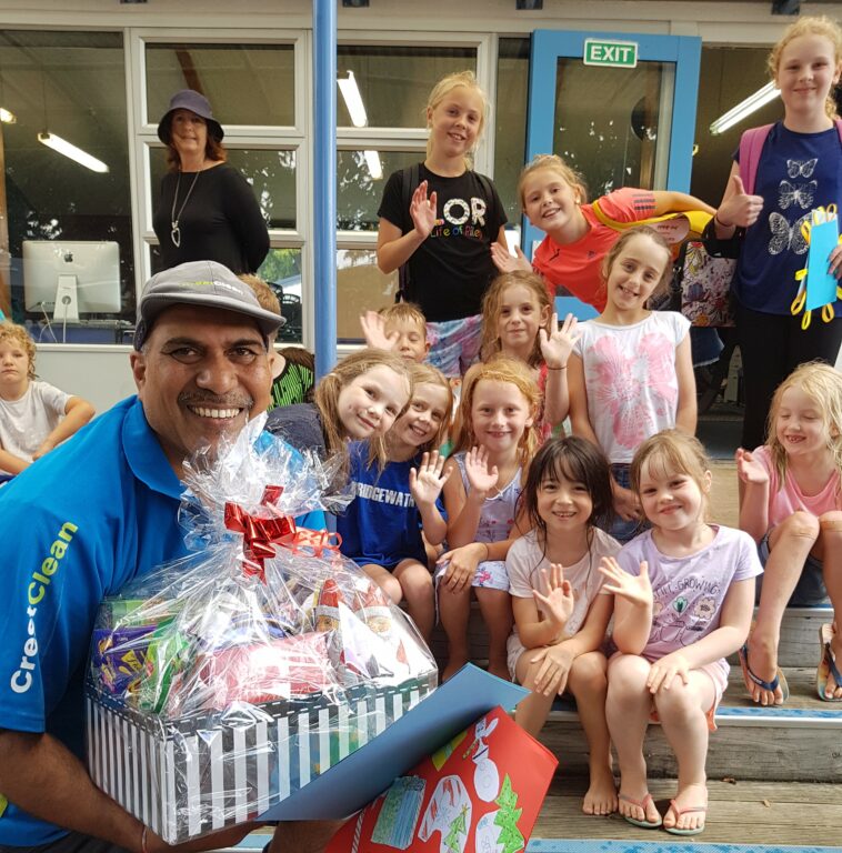 Krishn receives a Christmas hamper from Goodwood School students.