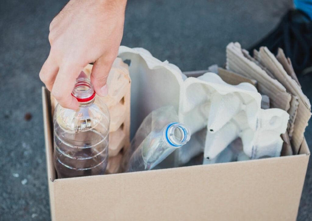 Collection of recycling including cleaned plastic bottles and cardboard.
