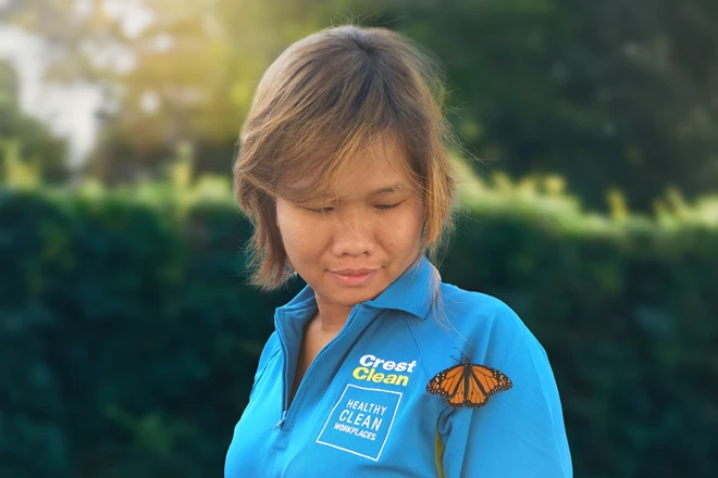 CrestClean cleaner with butterfly on shoulder depicting environmental sustainability concept
